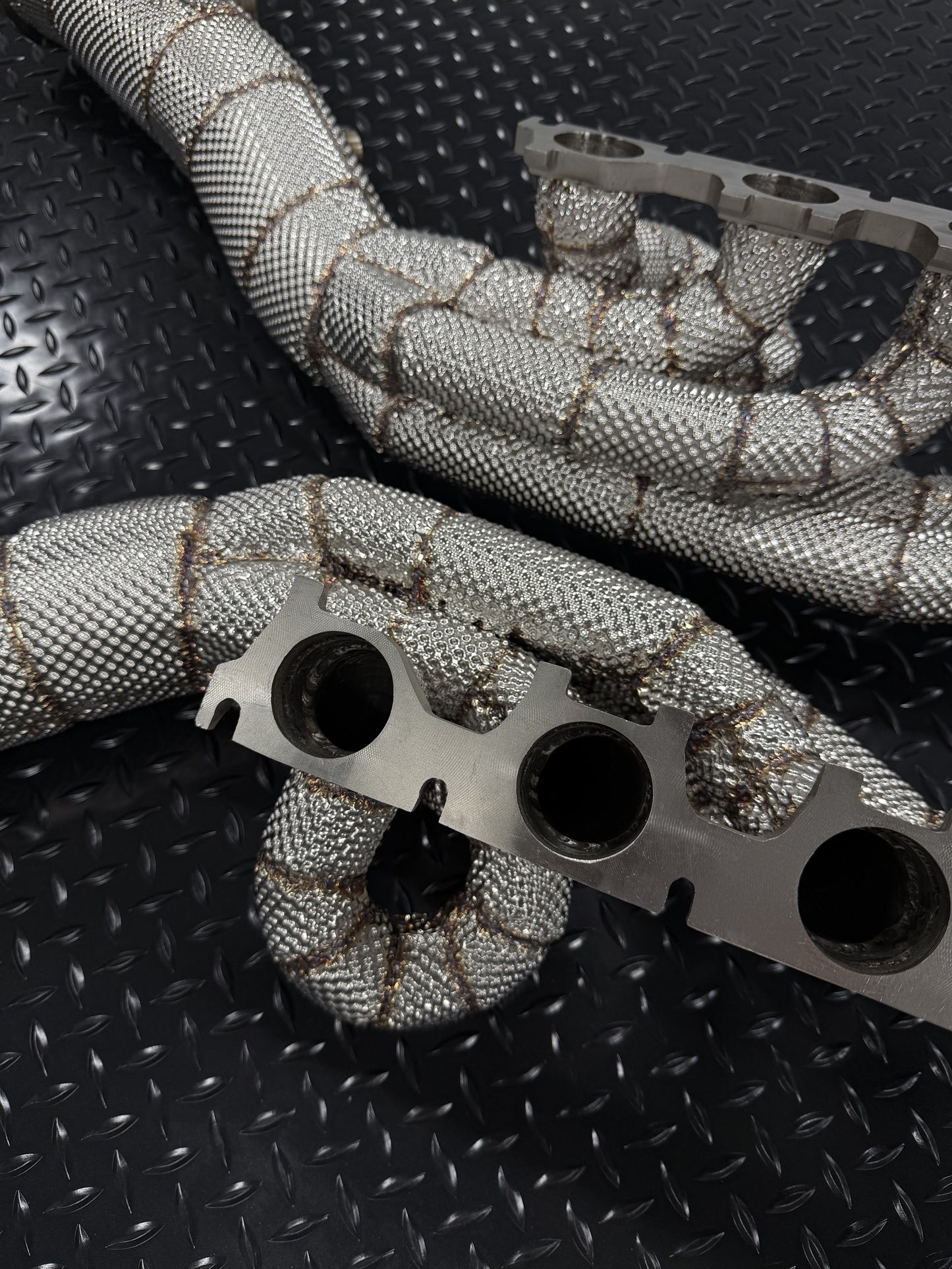 V10 header flange and heat-wrapped primaries, close-up