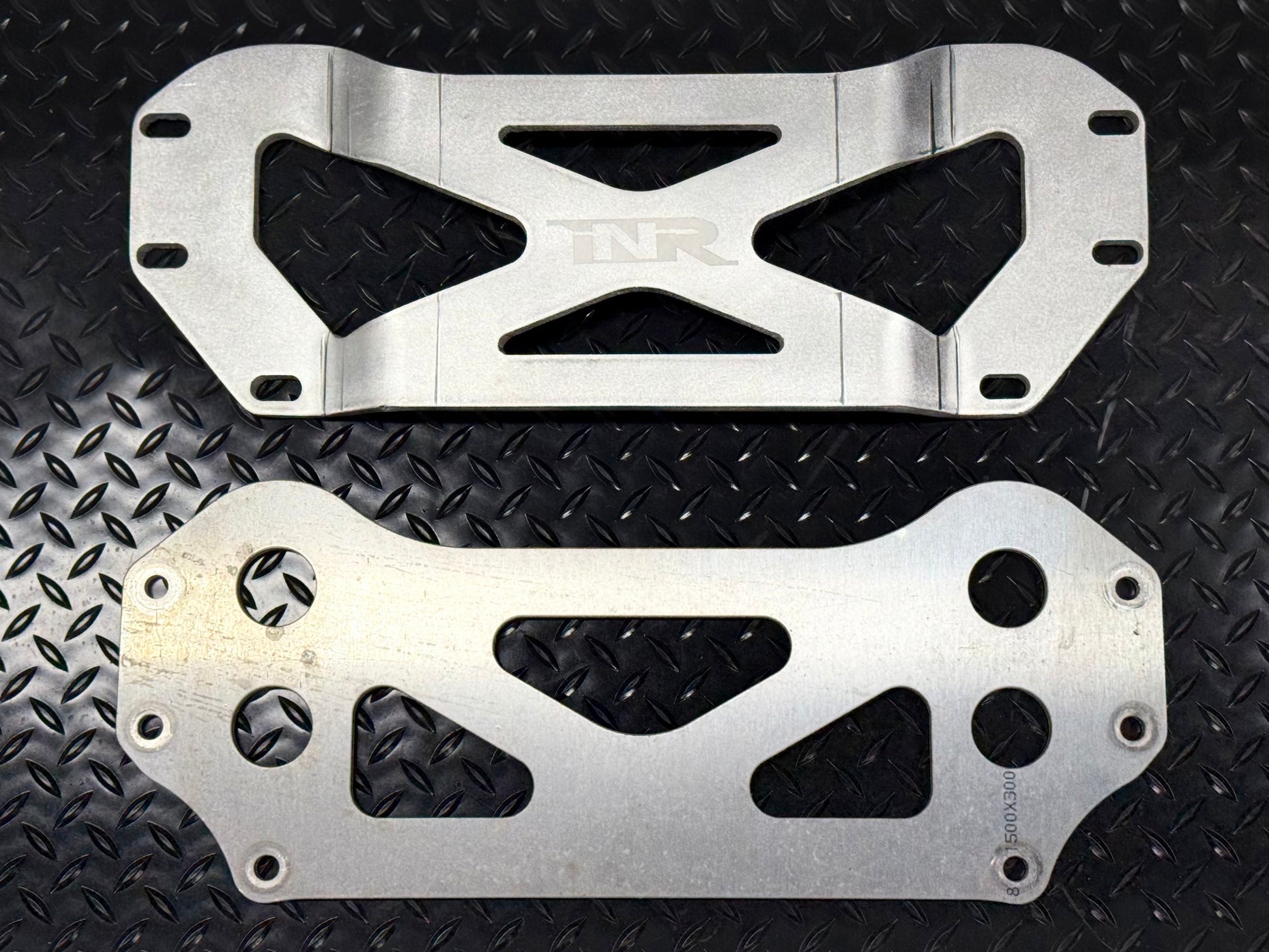 INR drop brace (top) beside the factory brace